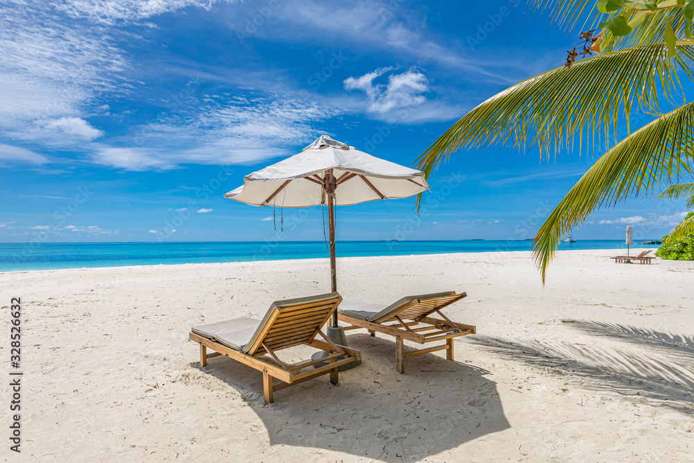 Chairs at the beach with white umbrella. Luxury beach vacation and summer travel landscape. Amazing summer mood, relaxation concept. Exotic nature, tropical pattern