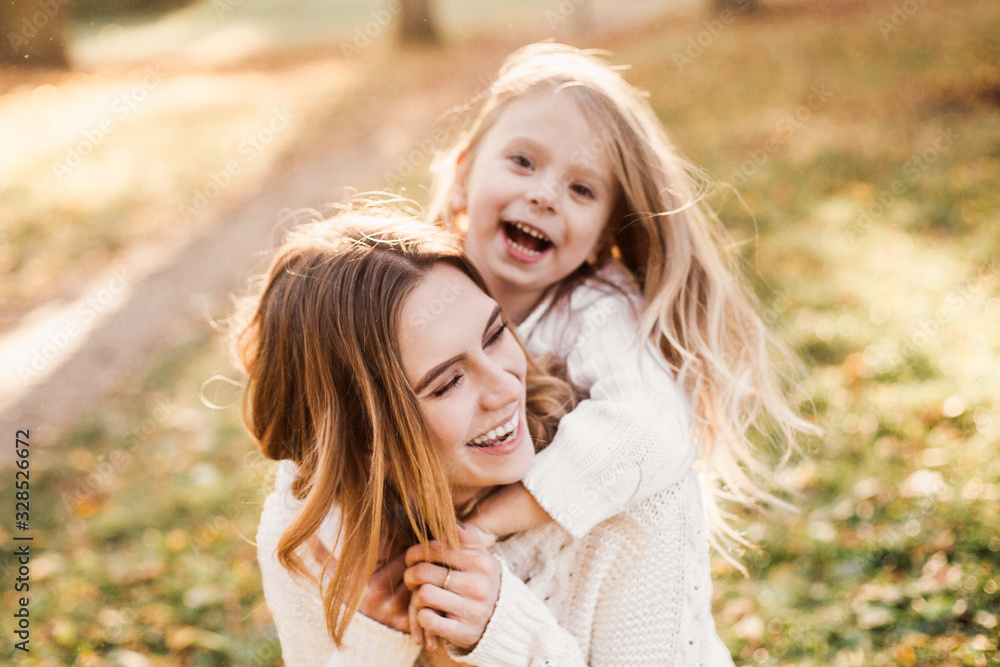 Happy daughter with mother is having fun walking in the park. Happy daughter with mother is having fun walking in the park.