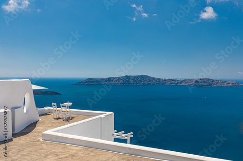 Couple honeymoon or romance background. Two chairs on the terrace with sea views. Santorini island, Greece. Romantic travel and vacation background