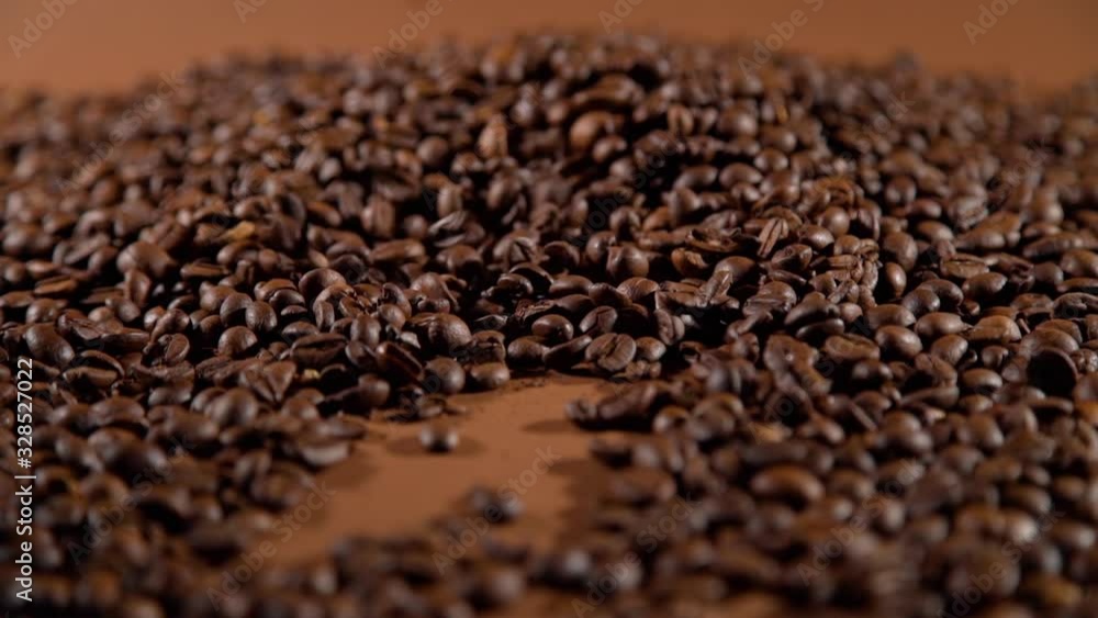 Closeup of Hand of a Woman Touching Arabica or Robusta Roasted Coffee Beans. Slow Motion. Food and Drinks Concept Closeup of Hand of a Woman Touching Arabica or Robusta Roasted Coffee Beans. Slow Motion. Food and Drinks Concept