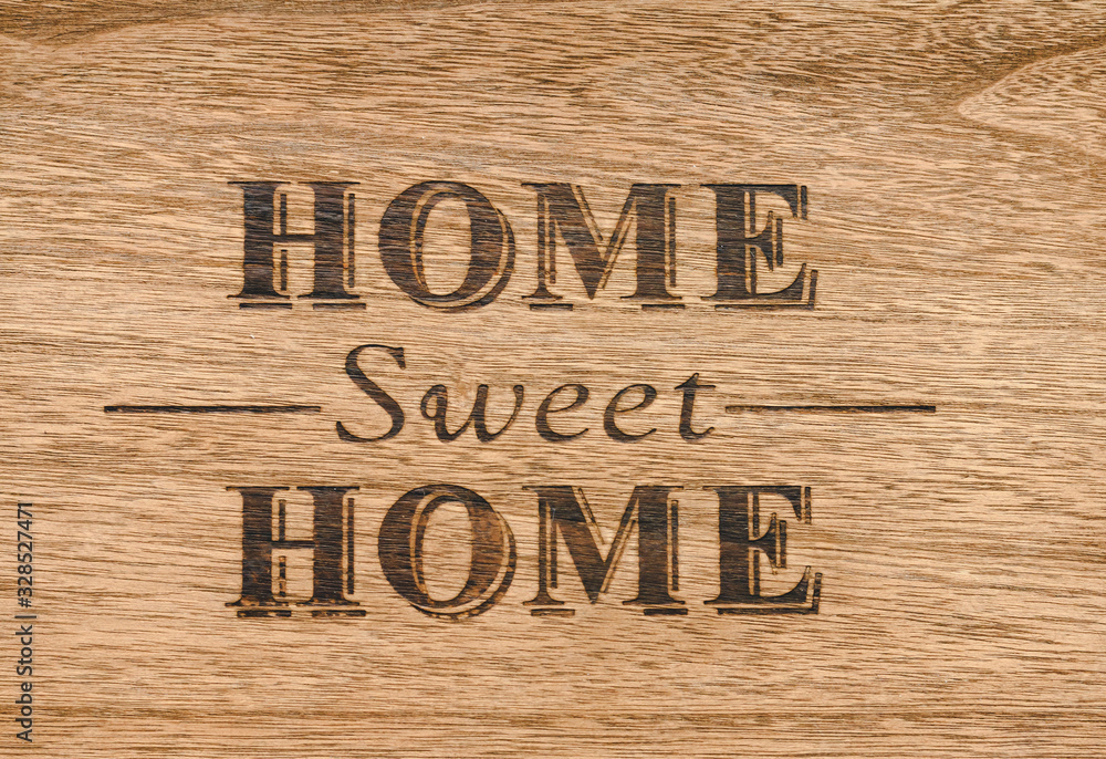 Home sweet home sign on a wood background