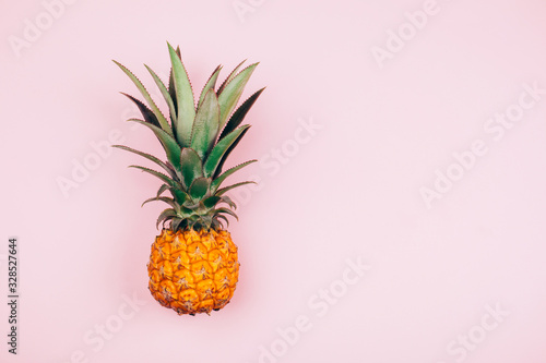 Yellow pineapple on stylish pink background. Flat lay style