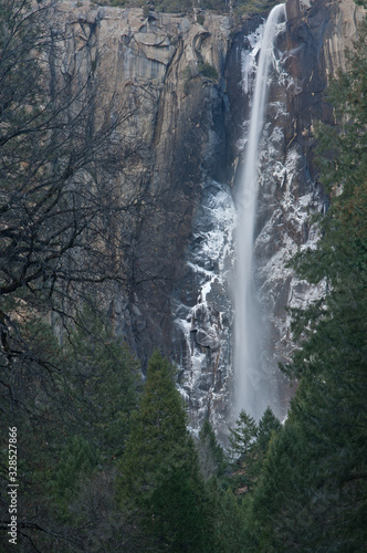 Winter landscape of Bridal Veil Falls with frosted cliff, Yosemite National Park, California, USA