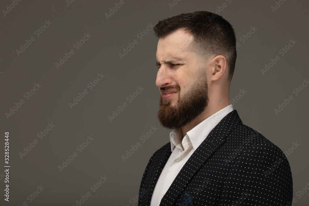 Portrait of a young bearded businessman crying. Portrait of a young bearded businessman crying.