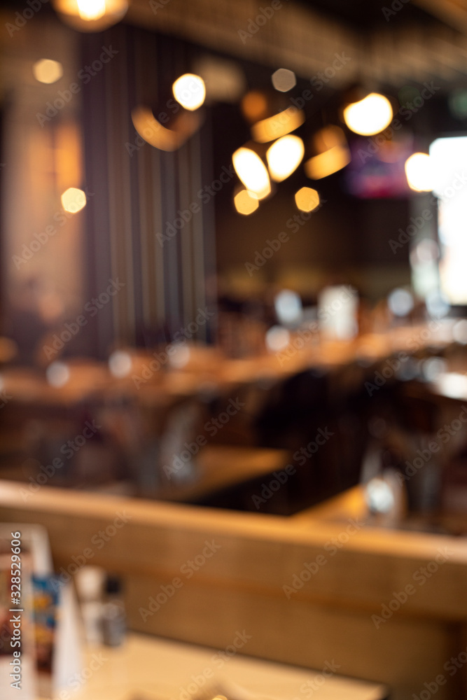 Blur light gold bokeh of cafe restaurant in dark background
