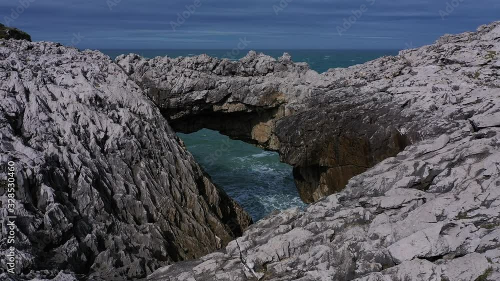 Aerial landscape of Cobijero beach and the natural arch El Salto del Caballo, Buelna, Asturias, Cantabrian Sea, Spain, Europe Aerial landscape of Cobijero beach and the natural arch El Salto del Caballo, Buelna, Asturias, Cantabrian Sea, Spain, Europe