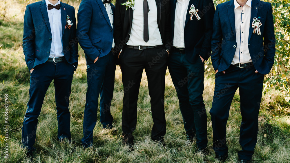 Wedding portrait groomsmen and groom. Young friends groomsman posing for camera. Cheerful friends outdoors. Wedding day. Wedding portrait groomsmen and groom. Young friends groomsman posing for camera. Cheerful friends outdoors. Wedding day.
