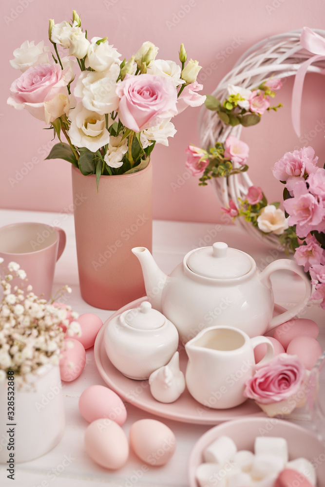 Easter table setting with cake,eggs and flowers. Happy Easter Greeting Card Template. Easter cake and colorful eggs on festive table. The concept of family celebration. Easter holiday. Easter table setting with cake,eggs and flowers. Happy Easter Greeting Card Template. Easter cake and colorful eggs on festive table. The concept of family celebration. Easter holiday.