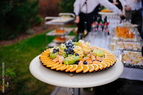 Canvas Print buffet in the open air. Plate fruit slicing.
