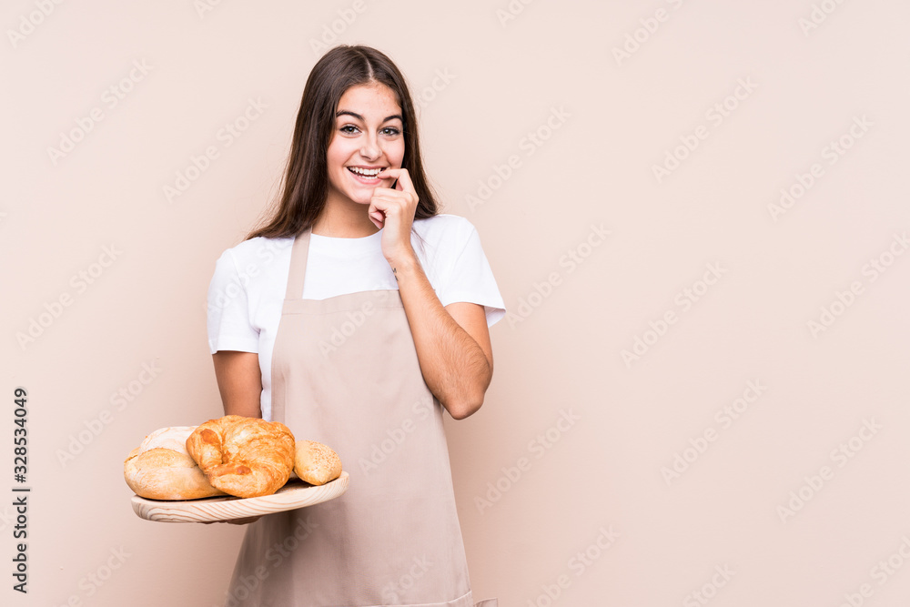 Young caucasian baker woman isolated relaxed thinking about something looking at a copy space.