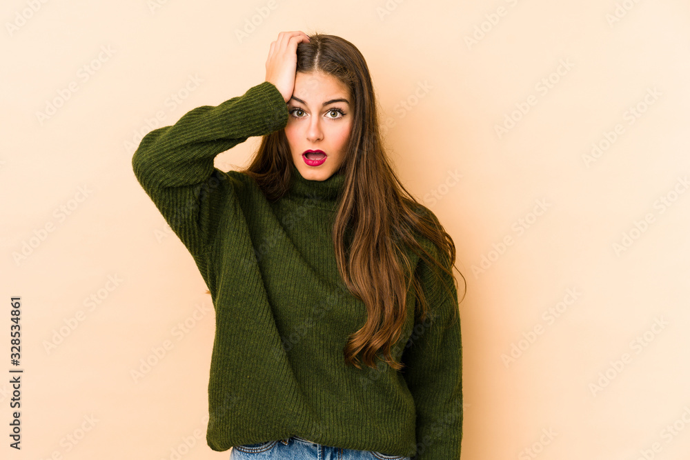 Young caucasian woman isolated en beige background being shocked, she has remembered important meeting. Young caucasian woman isolated en beige background being shocked, she has remembered important meeting.