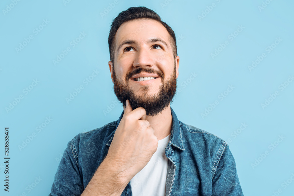 Fototapeta premium Pensive man on a blue background
