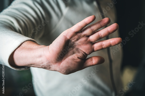 woman making stop gesture, focus on hand