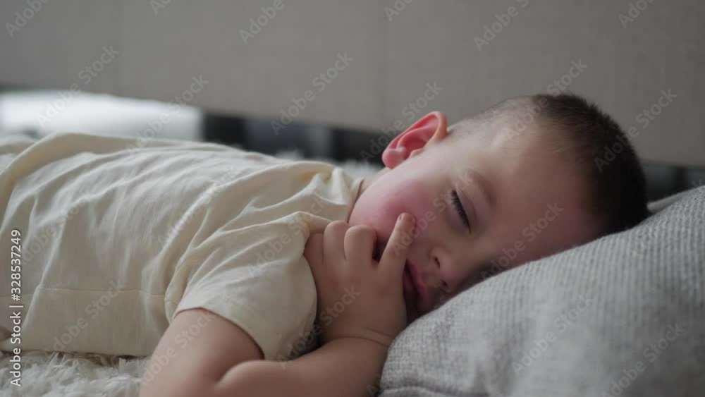 Adorable kid sleeping in bed, Sleeping little cute boy in his bedroom, Beautiful sleepy child Adorable kid sleeping in bed, Sleeping little cute boy in his bedroom, Beautiful sleepy child