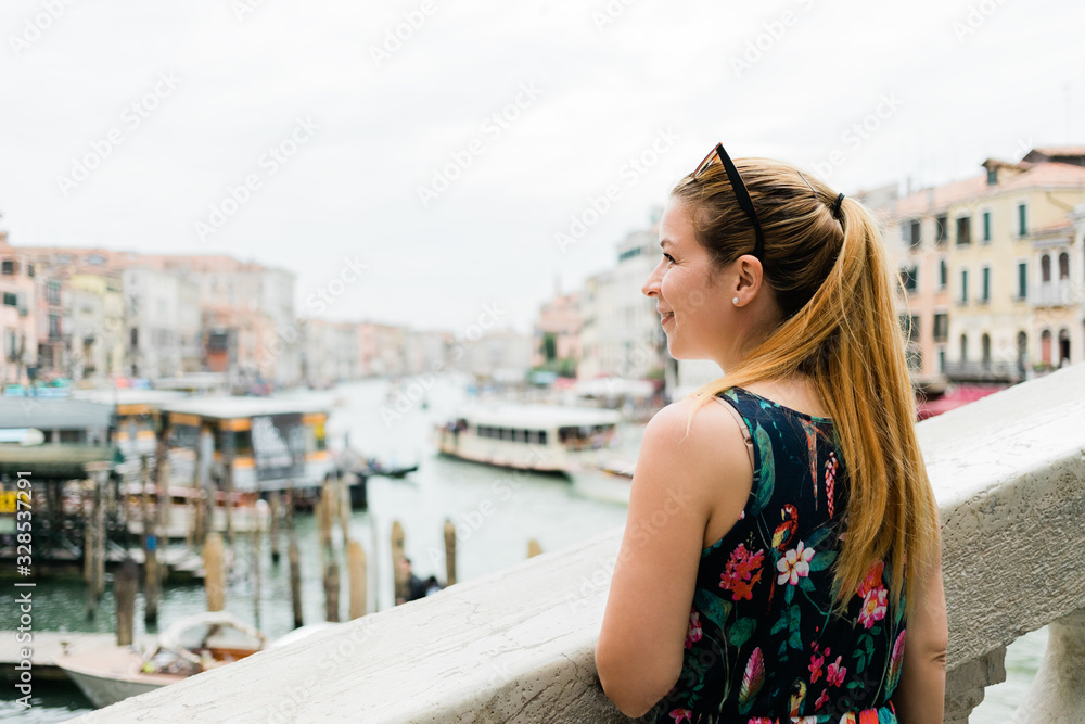 Young female traveler in Venice, Italy enjoying the view of the grand canal Young female traveler in Venice, Italy enjoying the view of the grand canal