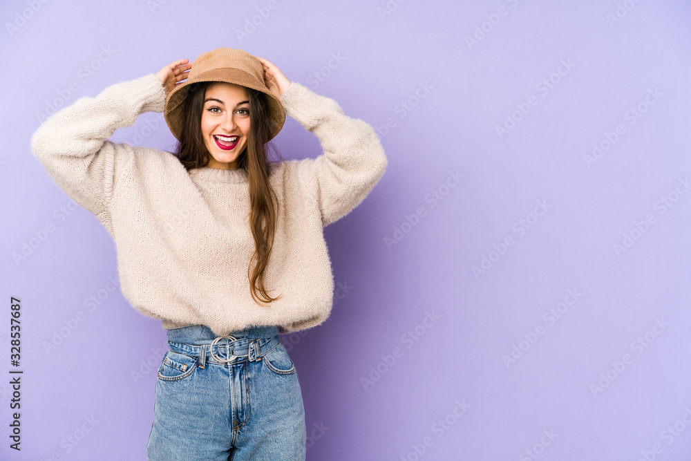 Young caucasian woman isolated on purple background screaming, very excited, passionate, satisfied with something. Young caucasian woman isolated on purple background screaming, very excited, passionate, satisfied with something.