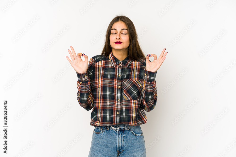 Young caucasian woman isolated on white background relaxes after hard working day, she is performing yoga. Young caucasian woman isolated on white background relaxes after hard working day, she is performing yoga.