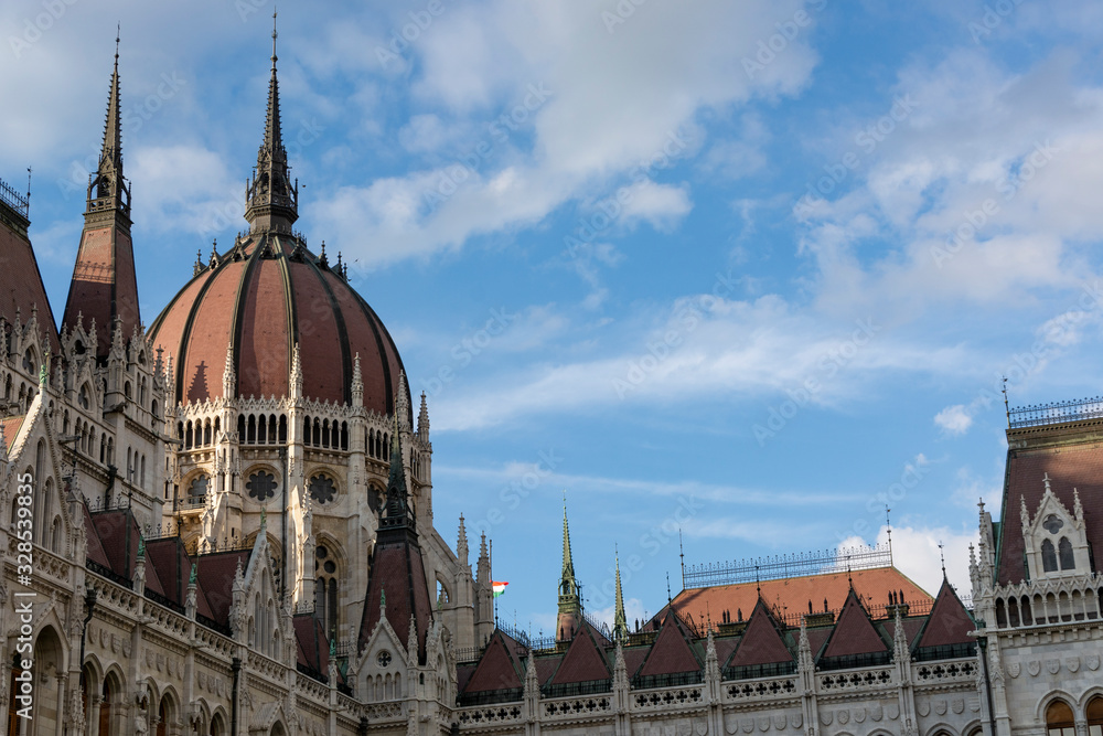 Detail image of the hungarian Parliament in Budapest. Blue sky with clouds.