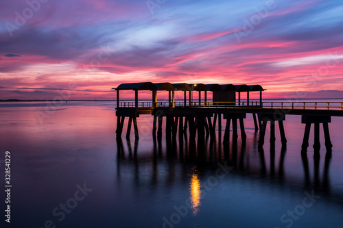 A beautiful ocean dramatic sunset and fishing pier at Jekyll Island in coastal Georgia, USA. photo