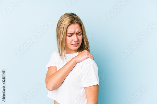 Young blonde caucasian woman isolated having a shoulder pain.