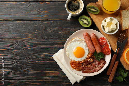 Delicious breakfast or lunch with fried eggs on wooden background, top view
