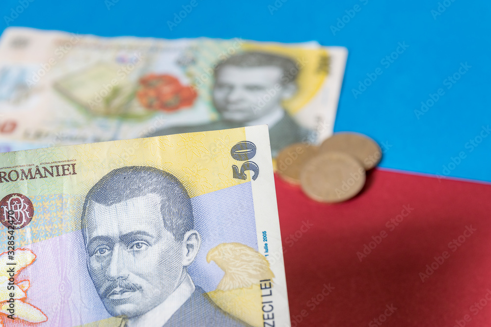 Romanian banknotes on a blue and red background. Coloseup of RON, Romanian Currency. Romanian RON, Lei Banknotes issued by BNR, National Bank of Romania. Romania Finance and economy concept