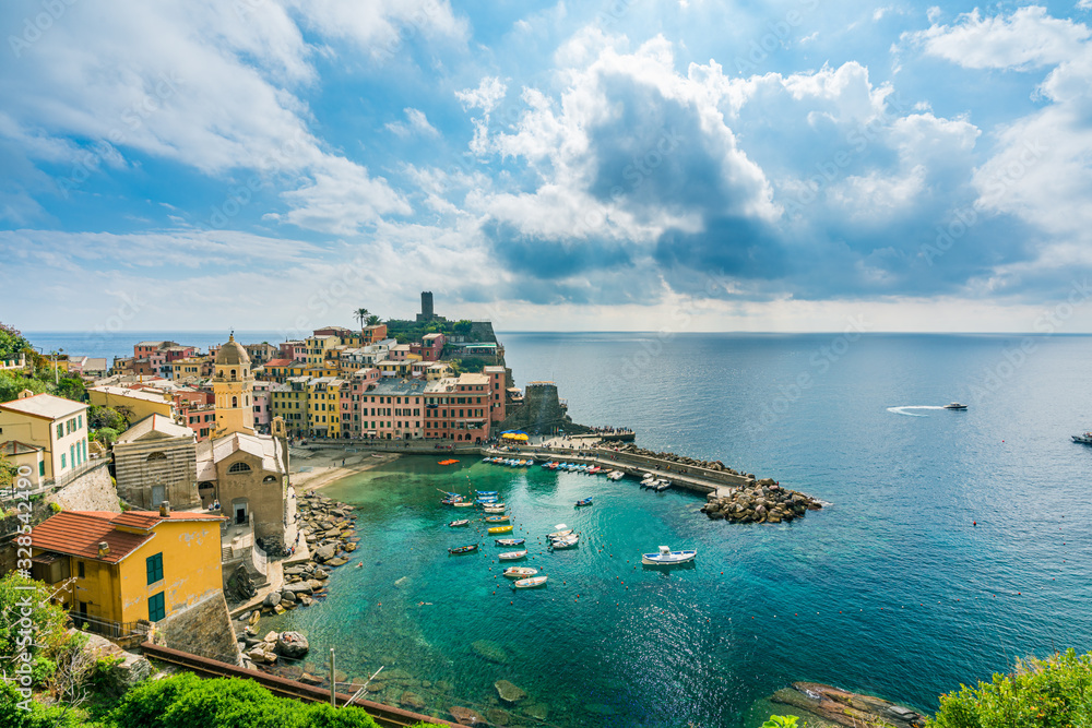 coastline and cityscape of colorful Vernazza village in Cinque Terre, Italy.