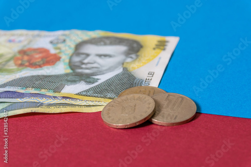 Romanian banknotes and coins on a blue and red background. Coloseup of RON, Romanian Currency. Romanian RON, Lei Banknotes issued by BNR, National Bank of Romania. Romania Finance and economy concept photo