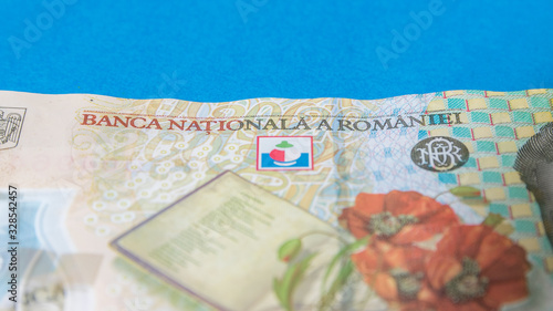 Obraz na płótnie Romanian banknotes on a blue and red background. Coloseup of RON, Romanian Currency. Romanian RON, Lei Banknotes issued by BNR, National Bank of Romania. Romania Finance and economy concept w salonie