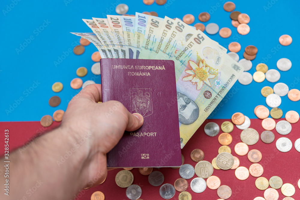 Romanian concept. The Romanian passport and Romanian banknotes/coins on a blue and red background. Coloseup of Romanian Passport and Romanian currency. Romania Finance and economy concept