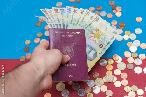 Romanian concept. The Romanian passport and Romanian banknotes/coins on a blue and red background. Coloseup of Romanian Passport and Romanian currency. Romania Finance and economy concept photo