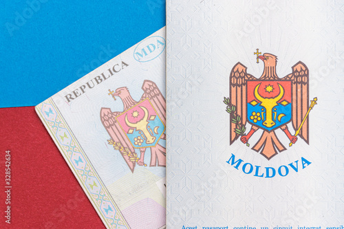 Obraz na płótnie Republic of Moldova concept. The Moldovan passport on a blue and red background. Coloseup of the emblem/coat of arms of Moldova. Moldova Finance and economy concept w salonie