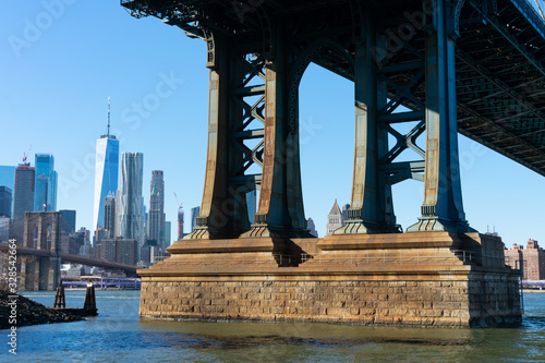 Base of the Manhattan Bridge along the East River with the Lower Manhattan Skyline in New York City