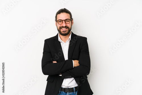 Young caucasian business man isolated on a white background laughing and having fun.