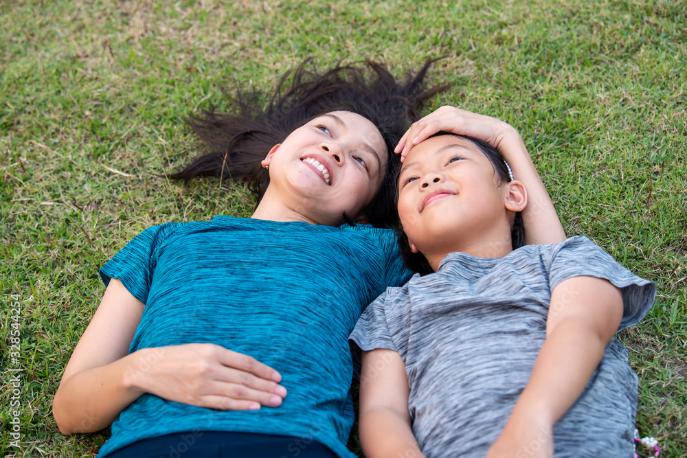 Mother and child hug each other warmly on the lawn,select focus. Mother and child hug each other warmly on the lawn,select focus.