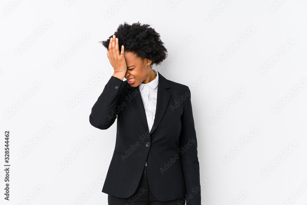 Middle aged african american business woman against a white background isolated forgetting something, slapping forehead with palm and closing eyes. Middle aged african american business woman against a white background isolated forgetting something, slapping forehead with palm and closing eyes.