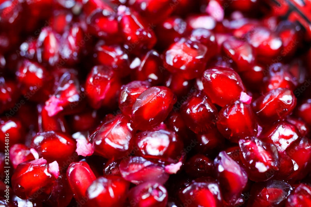 Macro full frame close up of red shiny juicy pomegranate seeds (focus on center) Macro full frame close up of red shiny juicy pomegranate seeds (focus on center)