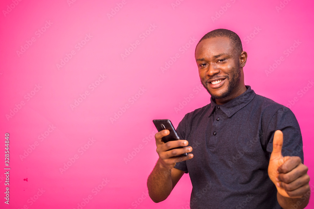 handsome young black man using his mobile phone handsome young black man using his mobile phone