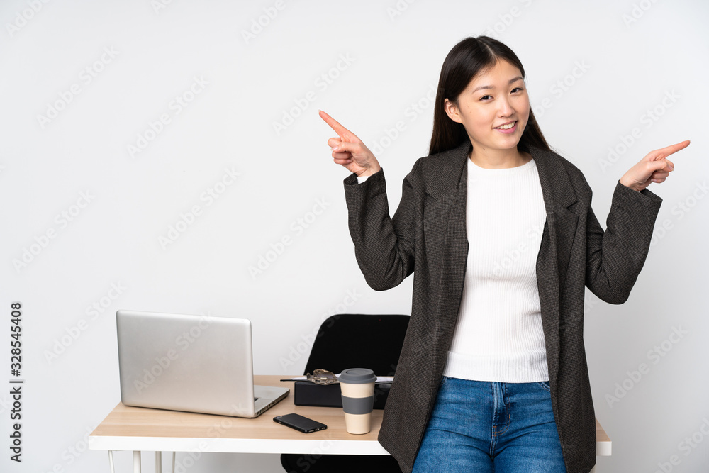 Business asian woman in her workplace isolated on white background pointing finger to the laterals and happy Business asian woman in her workplace isolated on white background pointing finger to the laterals and happy