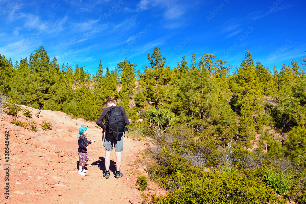 little girl and her dad hiking in a beautiful mountain setting