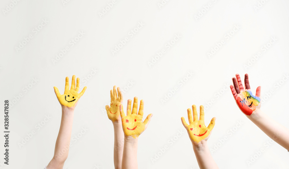 Close children's hands painted with yellow paint Close children's hands painted with yellow paint