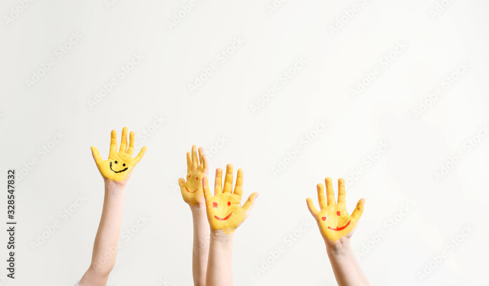 Close children's hands painted with yellow paint Close children's hands painted with yellow paint