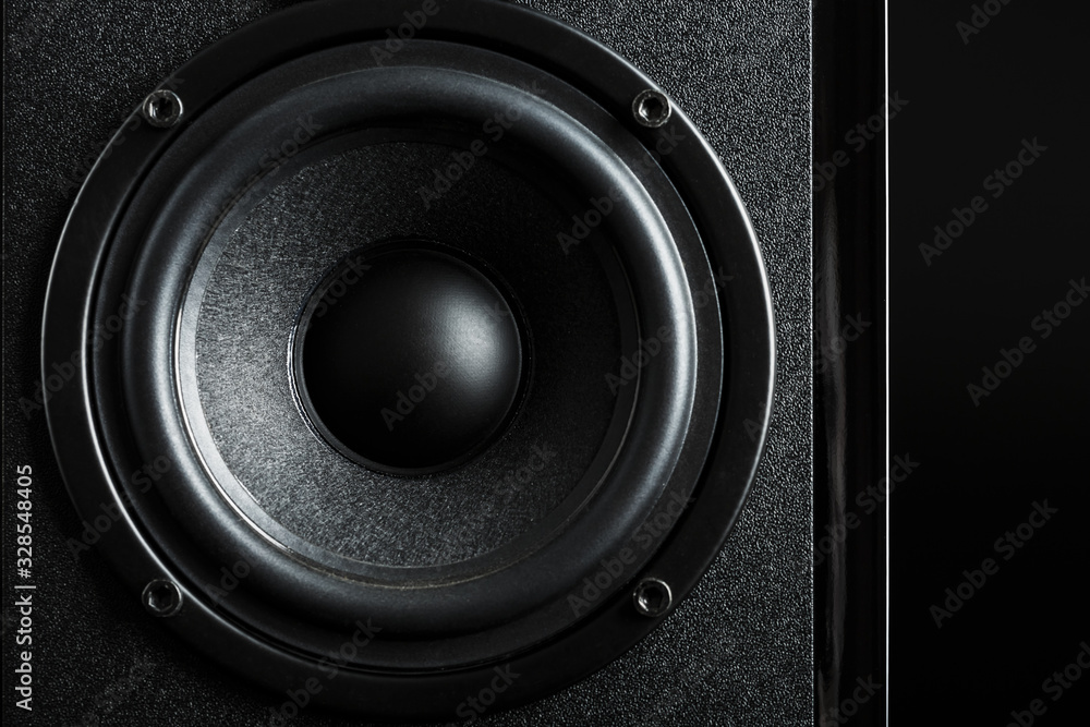 Multimedia speaker system speaker close-up on a black background. Multimedia speaker system speaker close-up on a black background.