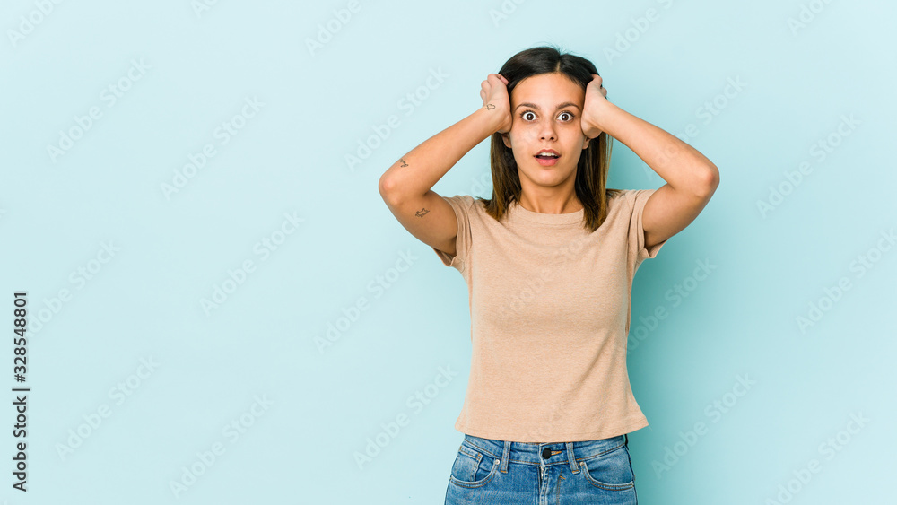 Young woman isolated on blue background being shocked, she has remembered important meeting. Young woman isolated on blue background being shocked, she has remembered important meeting.