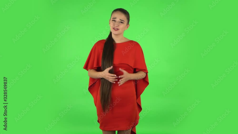 Pretty young displeased woman is indignantly talking to someone. Green screen Pretty young displeased woman is indignantly talking to someone. Green screen