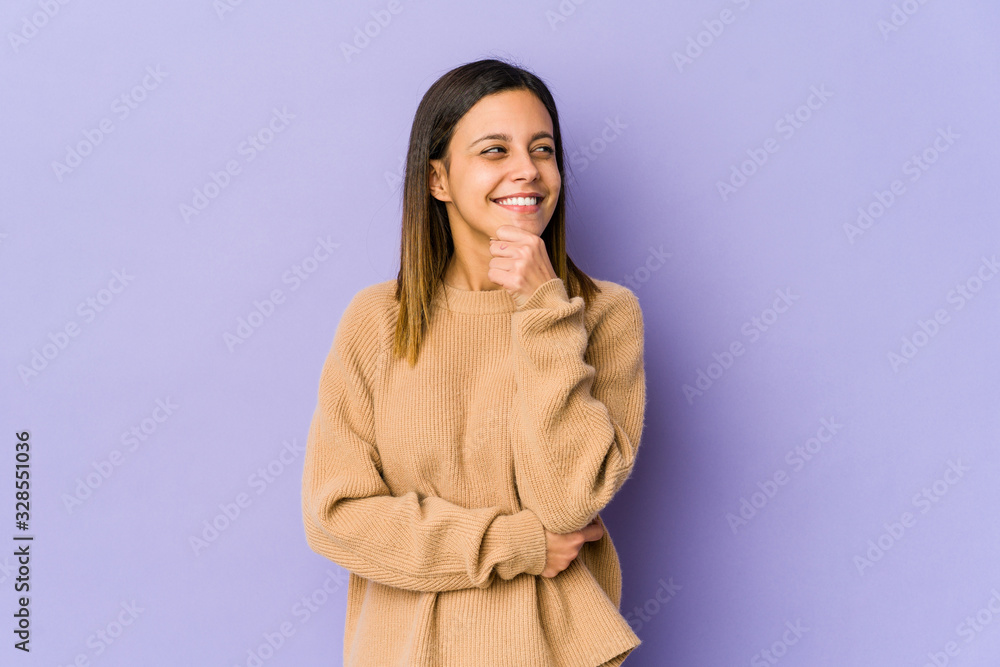 Young woman isolated on purple background looking sideways with doubtful and skeptical expression. Young woman isolated on purple background looking sideways with doubtful and skeptical expression.