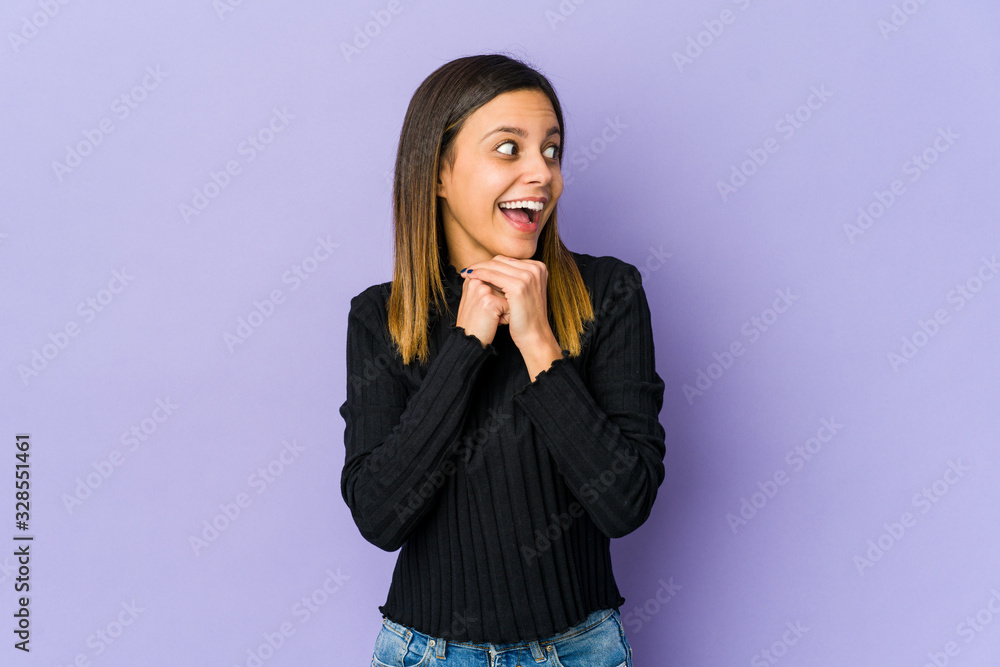 Young woman isolated on purple background praying for luck, amazed and opening mouth looking to front. Young woman isolated on purple background praying for luck, amazed and opening mouth looking to front.
