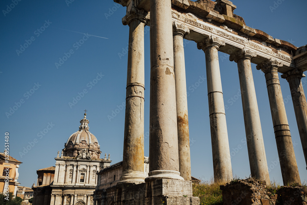 Ancient ruins of the Roman Forum. Ruins of Septimius Severus Arch and Saturn Temple, Rome, Italy. The Sacred Road, the main road of the Roman forum. Ancient ruins of the Roman Forum. Ruins of Septimius Severus Arch and Saturn Temple, Rome, Italy. The Sacred Road, the main road of the Roman forum.