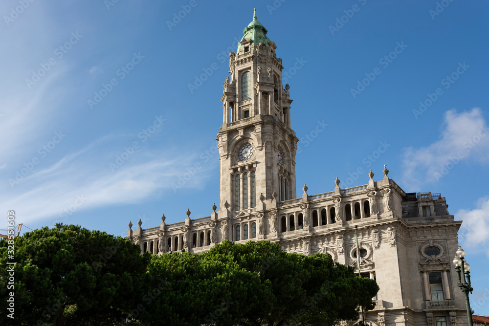 Porto City Hall. Pine trees. Blue sky with clouds.