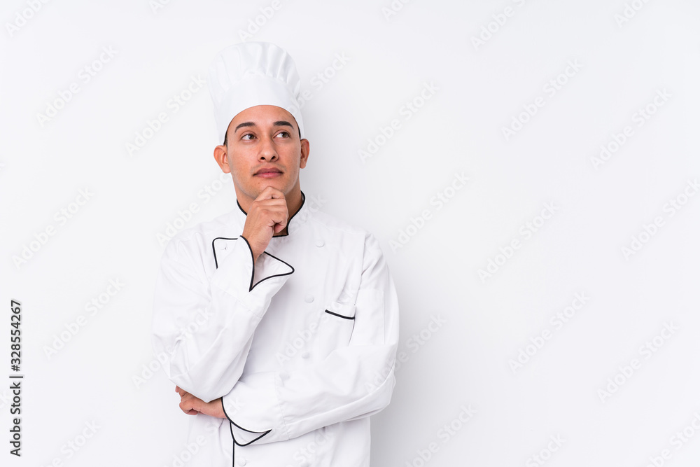 Young latin chef man isolated looking sideways with doubtful and skeptical expression. Young latin chef man isolated looking sideways with doubtful and skeptical expression.